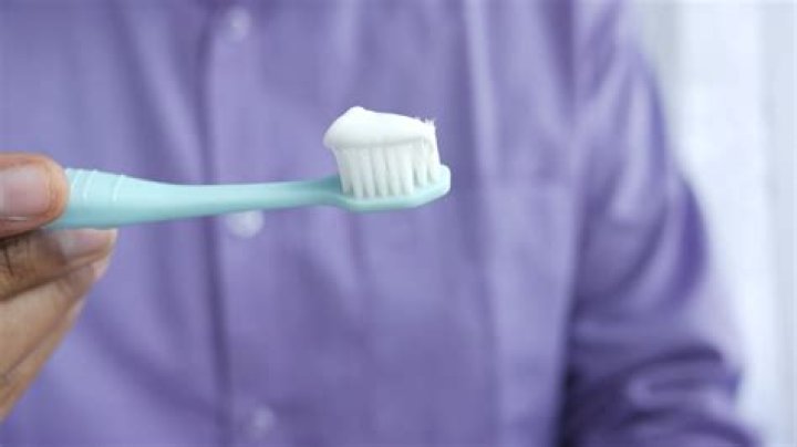 a man holding a toothbrush in his mouth